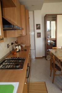 a kitchen with a stove and a counter top at Buonviaggio in La Spezia +25 photos