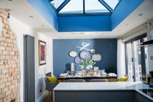 ein Esszimmer mit blauer Decke in der Unterkunft The Cottage, Gretton (Cotswolds) in Gretton