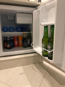 a refrigerator filled with lots of bottles of beer at B&B Rossini Luxury in Rende