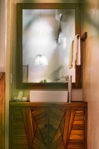 a bathroom with a sink and a mirror at ALCOBAS DEL MAR in Holbox Island