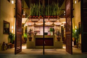 a lobby with potted plants and lights in a building at ALCOBAS DEL MAR in Holbox Island