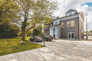 a house with two cars parked in a driveway at Pension Padre in Ostrava
