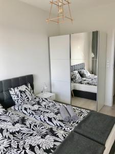 um quarto com uma cama grande e um espelho em Apartament Antoniny em Leszno