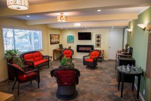 a waiting room with red chairs and a fireplace at Tea Garden Lodge in South Lake Tahoe