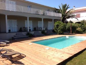 a swimming pool in front of a house at I Casilari in Serra-di-Ferro