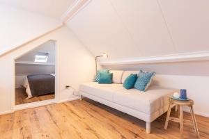 a room with a bed in a attic at Design City Center Family double floor apartment studio Delft C38 in Delft