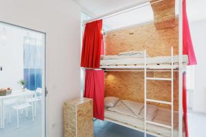 a bedroom with a bed and a window at Avenue Hostel in Budapest