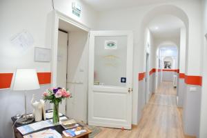 a hallway with white walls and orange accents at Torino 1854 Affittacamere in Turin