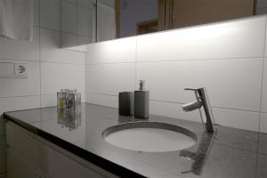a bathroom counter with a sink and a mirror at Om Apartments in Reykjavík +84 photos