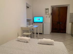een kamer met een tv en een tafel met handdoeken bij Berthollet 24 in Turijn