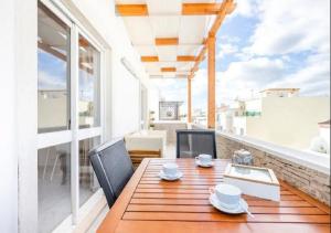 a wooden table and chairs on a balcony at My Place @ Faro Ria Views in Faro