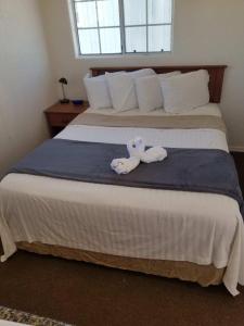 a stuffed animal is sitting on a bed at 075D Cozy Retreat nr South Rim Sleeps 2 in Valle