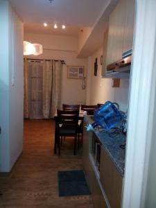 a kitchen and dining room with a table and chairs at Anya and Carl's Comfy in Mactan