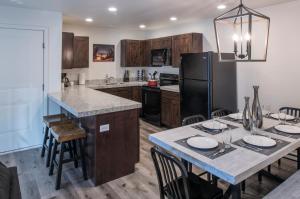 a kitchen with a table and a refrigerator at Moab Redcliff Condos in Moab