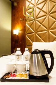 a coffee cup and a plate of food on a table at U3 HOTEL in Subang Jaya