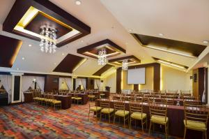 a conference room with tables and chairs and a screen at Hotel La Corona Manila in Manila