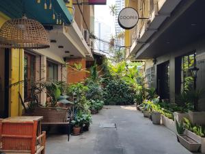 an alley with a bunch of potted plants in a building at Cooper in Bangkok