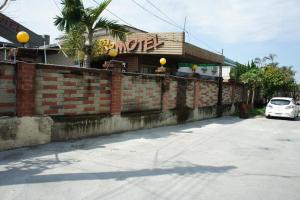 a car parked in front of a brick building at Paris Motel in Mailiao