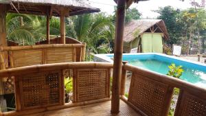 a wooden deck with a plunge pool on a house at Villa catalina Bora 2 Resort in Nabas