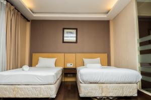 Ένα ή περισσότερα κρεβάτια σε δωμάτιο στο Spacious Studio Room at Grand Setiabudi Apartment By Travelio +12 φωτογραφίες