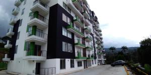 a black and white building with a car parked next to it at Apartamento Moniquira in Moniquirá