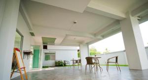 a room with chairs and tables in a building at The Meet Green Apartment in Bangkok