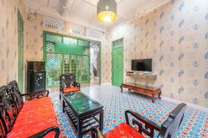 a living room with a table and a tv at Ama Hostel Bangkok in Bangkok