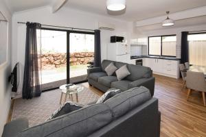 a living room with a couch and a table at Tootys Place in Margaret River Town