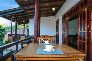 a wooden table on the balcony of a house at Kandyan Hideout in Kandy