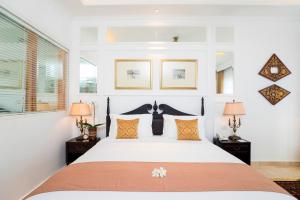 Postel nebo postele na pokoji v ubytování The Colony Hotel Bali