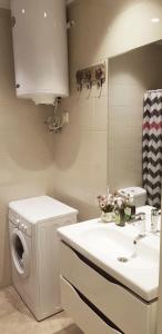 a bathroom with a washing machine and a sink at APARTMENT BATUMI BLACK PEARL in Batumi