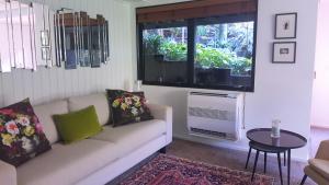 a living room with a couch and a window at Sequoia Steps in New Plymouth