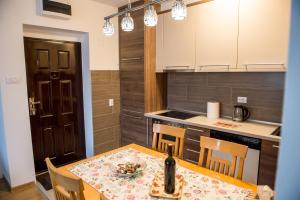 a kitchen with a table with a bottle of wine on it at Central Place in Trebinje