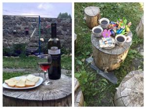 a bottle of wine and a plate of bread and a glass of wine at Sunny guesthouse in Kazbegi