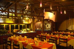 a dining room with tables and chairs and lights at Amboseli Serena Safari Lodge in Amboseli