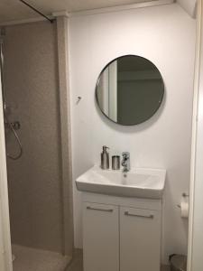 a bathroom with a white sink and a mirror at The Atlantic view guest house, Sandavagur, Faroe Islands in Sandavágur +44 photos