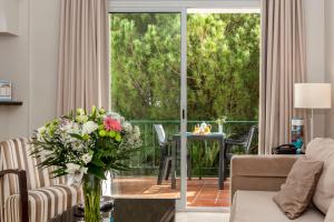 a living room with a glass door leading to a patio at Ona Alanda Club Marbella in Marbella