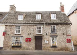 an old stone building with a brown door at Seven Stars in Hay-on-Wye