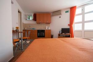 a kitchen with a large bed in a room at Studio and Room Lena in Dubrovnik