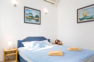 a bedroom with a bed with two towels on it at Apartments Irena in Becici