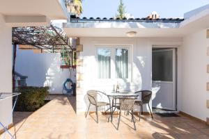 a patio with a table and chairs on it at Apartments Irena in Bečići