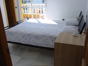 a bedroom with a bed and a window at Villa Mar - now with HEATED POOL! in Isla Canela +5 photos