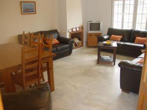 a living room with a couch and a table at Villa Mar - now with HEATED POOL! in Isla Canela