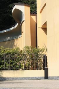 a building with a fence in front of it at Polo Hotel in Usmate Velate