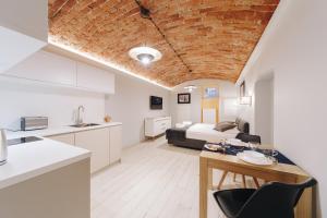 eine Küche und ein Wohnzimmer mit einem Zimmer mit einem Bett in der Unterkunft Platan Apartments - Ground Floor - Studencka 25 Street in Krakau
