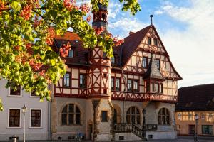 a large building with a tower on top of it at Hotel Waldoase Hirschbüchenkopf in Güntersberge