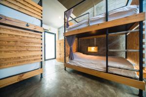 a bunk bed room with two bunk beds at ChillHub Hostel Phuket in Bang Tao Beach