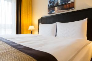 Un pat sau paturi într-o cameră la Hotel Euler Basel