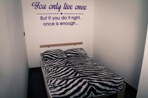 a bed in a room with a sign on the wall at Liams Mansion in Koper