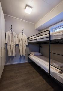 a room with two bunk beds and a wall mounted wall mounted wall mounted wall at Coal Miners’ Cabins in Longyearbyen